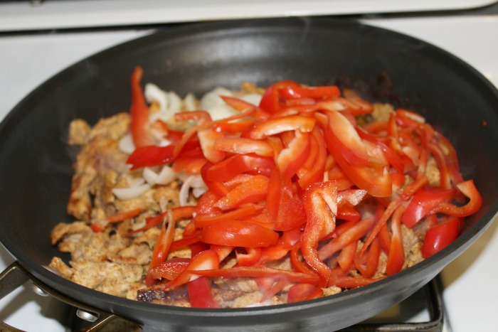 adding peppers and onions